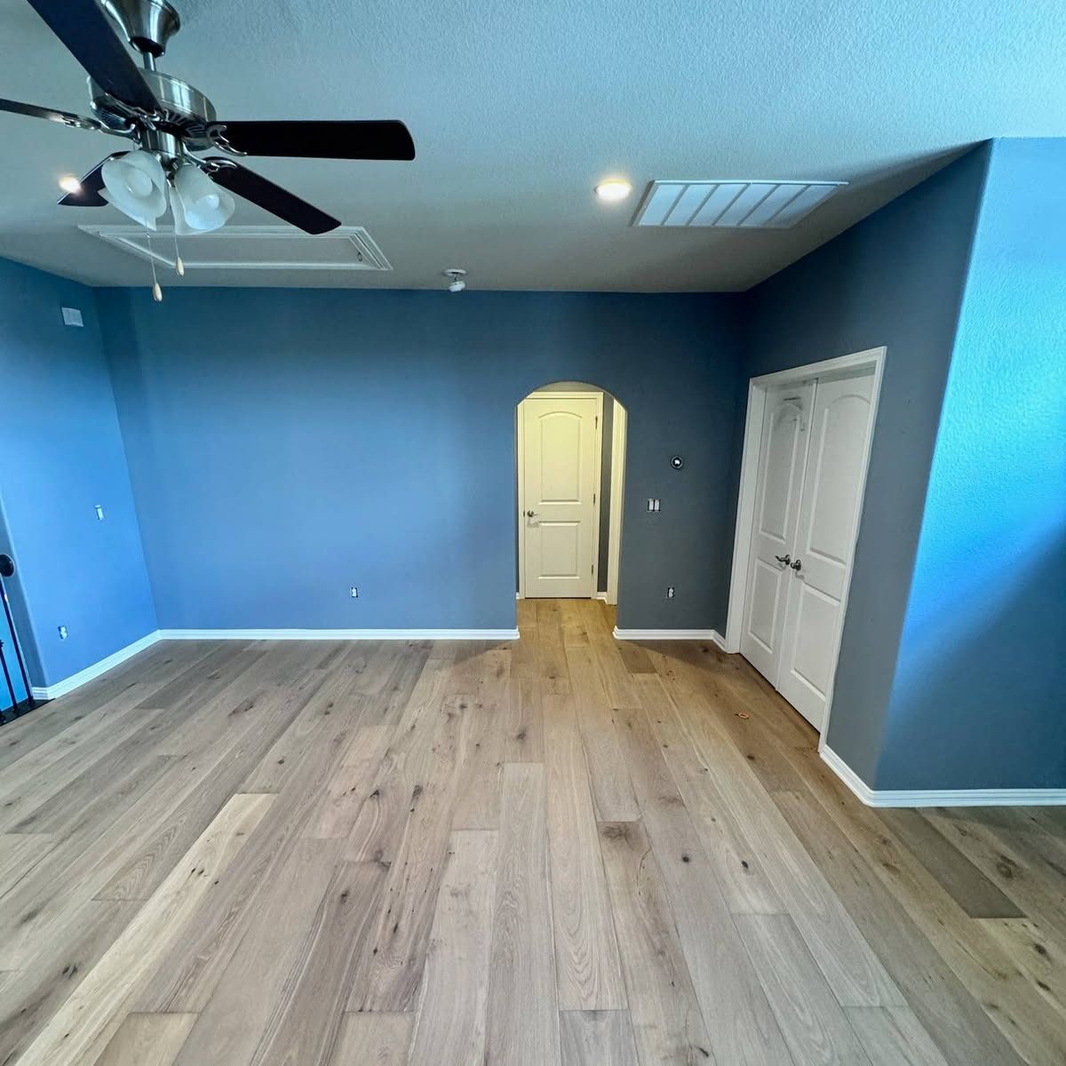 Bedroom with new wide-plank hardwood floors and fresh paint